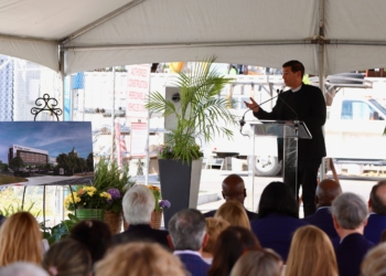 Photos by Mike Walsh
Father Jon Thomas, vicar general of the Diocese of Camden, blesses the 20-foot, 700-pound steel beam before it was raised into place June 9 atop Virtua’s Marvin Samson Pavilion at Our Lady of Lourdes Hospital in Camden.