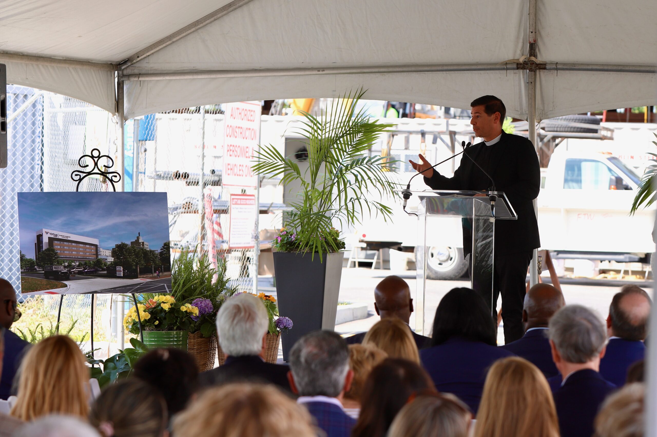 Photos by Mike Walsh
Father Jon Thomas, vicar general of the Diocese of Camden, blesses the 20-foot, 700-pound steel beam before it was raised into place June 9 atop Virtua’s Marvin Samson Pavilion at Our Lady of Lourdes Hospital in Camden.