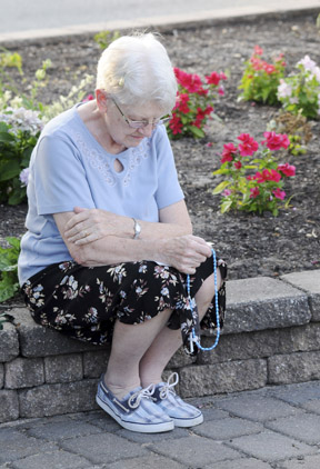 womanprayingrosary-web