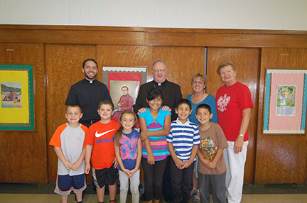 Photo by James A. McBride
Bishop Dennis Sullivan and Father Kevin J. Mohan, parochial vicar at Our Lady of Peace Parish, Williamstown, pose for a photo with the 2nd grade religious education class at St. Joachim Parish, Bellmawr, on Sept. 23. It was the second religious education program the bishop visited during the week.