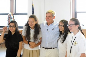 James Dunne, senior managing principal of the New York investment banking firm Sandler O’Neill and Partners, visited Our Lady Star of the Sea School, Atlantic City, Sept. 10, where he met with students and made a financial donation. He is pictured with Tuyen Hoang, a graduate who now attends Atlantic City High School; Michelle Carranza, seventh grade; Sakshi Harjani, seventh grade; and Samantha Smoger, a graduate and current student at Holy Spirit High School, Absecon. Photo by Alan M. Dumoff, ccdphotolibrary.smugmug.com .