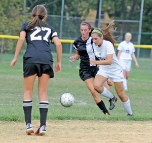 In girls’ high school soccer, visiting Bishop Eustace (Pennsauken) defeated the home team Camden Catholic (Cherry Hill), 3-0 on Sept. 11.  Above, members of the Crusaders and Irish fight for control of the ball. Photo by Alan M. Dumoff, ccdphotolibrary.smugmug.com 