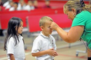 Teachers at St. Michael the Archangel School in Clayton blessed their students with holy water during a welcome back to school prayer service on Sept. 5. Above, students Xiomara Forster and Christopher Dender with first grade teacher Cheryl DeVecchis. Photo by Alan M. Dumoff, more photos ccdphotolibrary.smugmug.com 