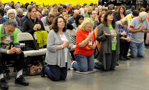 Worshippers kneel in prayer on Oct. 11, the second day of the 26th annual Charismatic Conference. It was held Oct. 10-12 at Wildwood Convention Center.