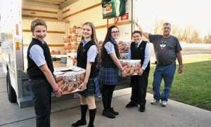 Students carry boxes of donated food to trucks at St. Mary School, Williamstown, and St. Joseph Regional School, Somers Point. The schools were among many schools and parishes in the Camden Diocese to hold a Thanksgiving food drives. Students carry boxes of donated food to trucks at St. Mary School, Williamstown, and St. Joseph Regional School, Somers Point. The schools were among many schools and parishes in the Camden Diocese to hold a Thanksgiving food drives. Top photo by Photo by Alan M. Dumoff 