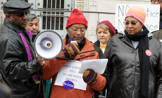 Father Gerard Marable, pastor of St. Josephine Bakhita Parish, Camden, speaks at a rally calling for changes to urban policing during a “Camden Die In,” held Dec. 12 on the steps of Federal Court House in Camden. Organized by the local activist group Camden Churches Organized for People, the event, and others held in cities across the country, was a response to the controversial deaths of Eric Garner, who died in an apparent choke hold in Staten Island, N.Y., and Michael Brown, a man who was shot by a police officer in Ferguson, Mo. “We stand in solidarity with our brothers and sisters in Ferguson and Staten Island, in expressing our grief at the loss of life they have experienced and outrage at the lack of police accountability in these cases. We feel compelled to say ‘enough is enough,’” said the Rev. Heyward Wiggins, III. “It is time for federal authorities to take concrete steps to increase police accountability and transparency, and to stop the senseless militarizing of our police departments in communities of color. Our police officers need to see themselves as part of the communities they serve, not armies of occupation.

Photo by Carl Peters