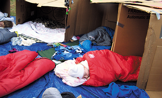 A religious education student sleeps in a cardboard box at Our Lady of the Angels Parish, Cape May Court House, Nov. 22, for a project to raise awareness of the needs of the homeless.