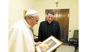 Msgr James F. Checchio, a priest of the Camden Diocese who serves as rector of the Pontifical North American College in Rome, presents a picture of Our Lady of Humility to Pope Francis Dec 18 at his residence, Casa Santa Marta. The pope gave Msgr. Checchio a ceremonial brick from the Holy Door of 2000 to be incorporated into the new 10-story tower recently completed at the North American College.