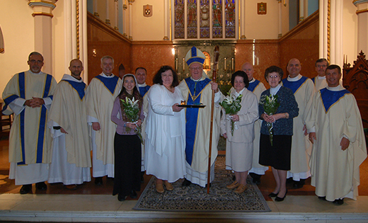 AnnaMae Muryasz stands to the left of Bishop Dennis Sullivan in the Cathedral of the Immaculate Conception, Camden, on Jan. 21 following the Rite of Consecration to a Life of Virginity. Also pictured, from left, are Deacon Jerry Jablonowski; Father Hugh McSherry, OFM; Father Michael Field; Christina Hip-Flores, Consecrated Virgin, Archdiocese of Santiago de Cuba; Father James Bartoloma; Dr. Jewel Brennan, Consecrated Virgin, Diocese of Trenton; Father Robert Hughes; Carolyn Blaszczyk, Consecrated Virgin, Diocese of Harrisburg; Father Nicholas Dudo; Deacon Michael Carter; and Father Joseph Wallace.

Photo by James A. McBride