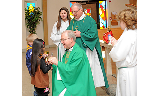 Father Vincent G. Guest, pastor of Holy Cross Parish, Bridgeton, accepts the offertory gifts Feb. 1 at a Mass celebrating 50 years of Scouting in the community.

Photo by Alan M. Dumoff, more photos http://ccdphotolibrary.smugmug.com