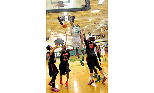 In boys’ high school basketball, Camden Catholic, Cherry Hill, defeated visiting St. Joseph, Hammonton, 65-30 on Jan. 30. The Irish’s Courtney Cubbage scores 2 over Wildcat defenders.

Photo by Alan M. Dumoff, http://ccdphotolibrary.smugmug.com