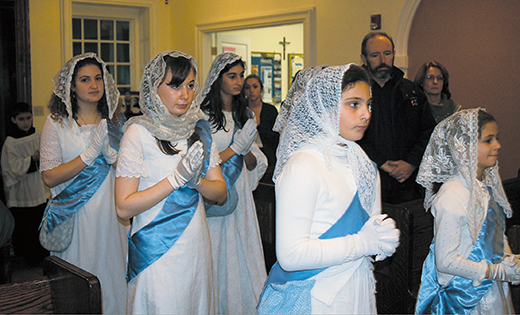 Blessed Imelda Society Girls Annie Byrne, Brigid Byrne, Francesca Consoli, Isabella Thomas and Evangelia Tonelli of Mater Ecclesiae Mission, Berlin, process into the church during the community’s Candelmas celebration Feb. 2. Bishop Dennis Sullivan was the principal celebrant.

Photo by Peter G. Sánchez