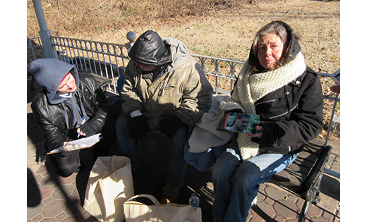 A homeless woman holds a photograph of her dead son, while her companion answers survey questions for Jeffrey Kates of Catholic Charities (kneeling). A bi-annual homeless census called the Point in Time survey is required of each county by the U.S. Department of Housing and Urban Development. The numbers determine how much funding will be given to the county the coming year in homelessness prevention and housing assistance grants.

Photo by Joanna Gardner