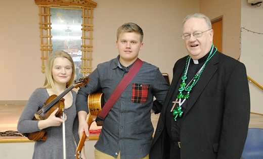 On March 13, Bishop Dennis Sullivan lent his voice to the Irish music of Haley and Dylan Richardson during a surprise early birthday present for the Camden leader, whose birthday is March 17, St. Patrick’s Day. The birthday celebration was part of a diocesan Lenten Day of Recollection, held at Holy Family Parish, Sewell.

Photo by Maria D’Antonio