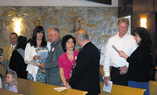 Couples hold hands and renew their marriage vows at the Camden Diocesan Wedding Anniversary Mass. Bishop Dennis Sullivan celebrated the Mass April 19 at St. Gianna Beretta Molla Parish, Northfield, for couples observing milestone anniversaries.

Photo by James A. McBride