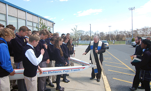 Bishop Dennis Sullivan blesses two new crew boats during a visit to Holy Spirit High School, Absecon, on April 24. One of the boats is named for the bishop, and the other is named for Pope Francis.

Photo by James A. McBride