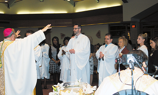 Bishop Dennis Sullivan blesses those newly-received into the Catholic Church at the Easter Vigil at St. Andrew the Apostle in Gibbsboro, on April 4.

Photo by James A. McBride