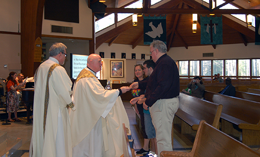 Father Robert Hughes, vicar general of the Diocese of Camden, accepts the offertory gifts from Cheryl LaSpada and her son Tyler and Stephen Francis Kline during a diocesan Eucharistic celebration in observance of Autism Awareness Month April 12 at Holy Family Parish, Sewell. At left is Deacon Gerald J. Jablonowski, director of Home and Parish-based Healthcare Services for the diocese.

Photo by James A. McBride