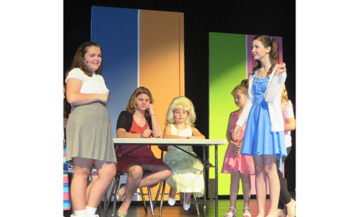 Kendall DeVecchis, Olivia Marchei, Stephanie DiMeo and and Nicole D’Arecca act in the St. Michael the Archangel Regional School, Clayton, production of Hairspray Jr. at Glassboro High School on April 17.