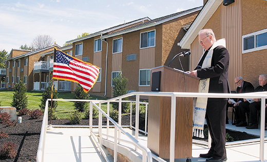 Bishop Dennis Sullivan blesses the Village Apartments of Cherry Hill on April 30 at a rededication ceremony, which brought together local clergy, community members, and members of the Camden Diocesan Housing Services Corporation. Built in 1983, the Village Apartments of Cherry Hill have 150 studio and one-bedroom units for low-income seniors and disabled residents. Recent improvements to the site have included new roofing, painting, carpeting, a community garden, and patios and decks attached to the studio apartments.

Photo by James A. McBride