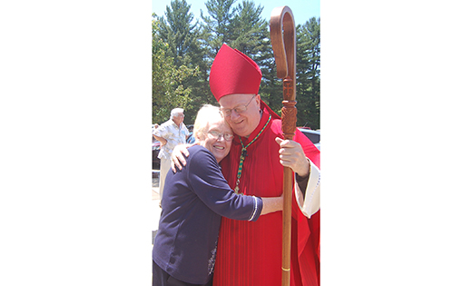 Sharon Fileccia hugs Bishop Dennis Sullivan following the fifth anniversary Mass of the parish of the Holy Spirit in Mullica Hill on Pentecost Sunday.

Photo by James A. McBride