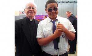 Msgr. Michael Doyle, pastor of Sacred Heart Parish, Camden, and Jorge Cartagena wait to greet President Obama at the Salvation Army Ray and Joan Kroc Corps Community Center in Camden on May 18.