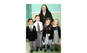 Sister Armida, a Missionary Daughter of the Most Pure Virgin Mary, stands with children of St. Peter School, Merchantville.