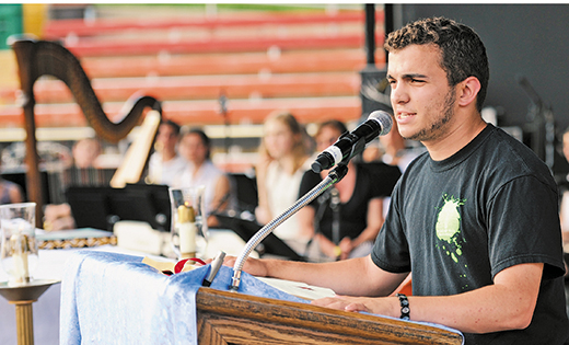 Joseph Fiore reads the first reading at the New Jersey Catholic Youth Rally held at Six Flags Great Adventure, Jackson, N.J., on May 17. Fiore, of Our Lady of Peace Parish, Williamstown, is a member of the parish ACTS (Aspiring Catholics Taking a Stand) young adult ministry and is also a volunteer for youth ministry programs.

Photo by Alan M. Dumoff, http://ccdphotolibrary.smugmug.com