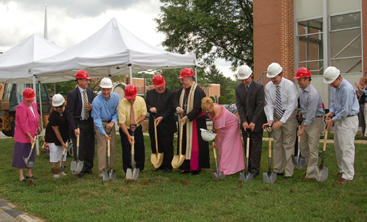 Bishop Dennis Sullivan, with Father Thomas Newton, pastor, to his left, and surrounded by parish and school staff and community members, breaks ground for the planned parish center and gymnasium at Christ Our Light Parish in Cherry Hill, June 5. At far left is Sister Lydia Etter, OSF, principal of Resurrection Catholic School.

Photo by James A. McBride