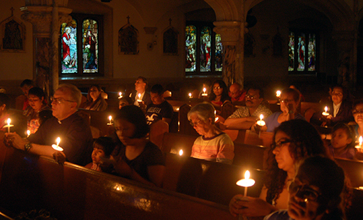 Parishioners from the Parish of the Holy Cross in Bridgeton prayed a multi-lingual living rosary at the Church of the Immaculate Conception on May 28 for the intentions of the unity of the family and vocations. Pastor Father Vince Guest explained that “in this Year of the Family we want to gather all of our parishioners to pray for and with each other.” Father Guest stated that “we are a multi-lingual and diverse community but we are united in the love of our Catholic faith.” Worshippers held candles, and as each Hail Mary was prayed a parishioner’s candle was lit. The rosary was prayed in Spanish, English, Italian, Polish and German. Future events for the family at Holy Cross include a novena to St. Anne in July to pray for grandparents and a children’s liturgy in the fall.

Photo by James A. McBride