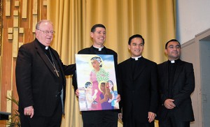 Bishop Dennis Sullivan stands with the three priests that will staff the newly-created Parish of St. Monica: Father Jon Thomas, pastor, and Father Thanh Pham and Father Fernando Carmona, parochial vicars. Father Thomas holds a painting of St. Monica specifically created for the new parish by Brother Michael O’Neill McGrath. Bishop Sullivan announced the merger at a press conference June 5 in Atlantic City. Photo by James A. McBride