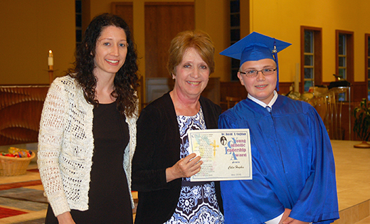 Katharine Coghlan, center, and Katie Coghlan Jackson present the David T. Coghlan Young Catholic Leader Award Scholarship to Colin Hughes at his graduation from Resurrection Catholic School in Cherry Hill.

Photo by James A. McBride