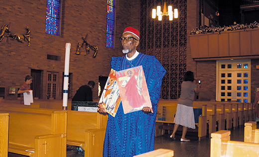 Abdullahi Suleiman carries images of the Ugandan Martyrs at the annual Mass remembering St. Charles Lwanga and his 24 companions, held June 6 at St. Rose of Lima Church in Haddon Heights.

Photo by James A. McBride