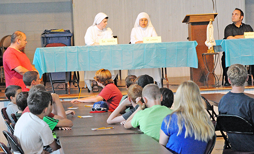 Sister Karen McConnell, FMIHM, and Sister Cherry Butaslac, SOM, take questions from youth at Theology on Ice on July 13 at Our Lady of Sorrows Parish in Linwood.

Photo by Alan M. Dumoff