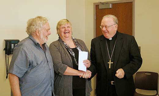 Bishop Dennis Sullivan congratulates Stephen Ellsworth and Christina Silvaria of Blessed Teresa of Calcutta, Collingswood, who will be attending the World Meeting of Families theological congress in Philadelphia. The bishop introduced them and other families who will attend the congress, with passes awarded by Catholic Charities, at a press conference Aug. 17 to introduce the diocese’s 40 Days for Francis anti-poverty campaign.

Photo by James A. McBride