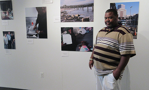 Photo by Joanna Gardner

Shakir Abdusallam stands with several of his photos, part of an exhibit featuring the work of laid off casino workers, at the Noyes Art Garage in Atlantic City.