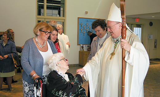 Bishop Dennis Sullivan greets Doris Hellmund at St. Thomas More Parish, Cherry Hil, in April 2014. The sale of the nursing homes is expected to help the Camden Diocese community-based ministries of care for seniors and other groups. “Future trends resulting from the government’s managed-care programs, whose goal is to enable people to remain in their homes and receive needed care there, reinforced this conclusion,” said Deacon Gerard Jablonowski, PT, MS, the director of Home and Parish-Based Services for the diocese.

Photo by James A. McBride