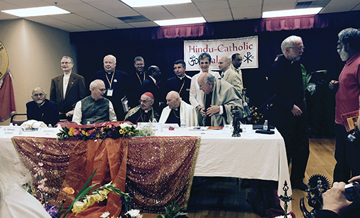 Cardinal Jean-Louis Tauran, (seated, center), president of the Vatican’s Pontifical Council for Interreligious Dialogue, is pictured May 19 at The Catholic University of America in Washington. Father Joseph D. Wallace is behind him.