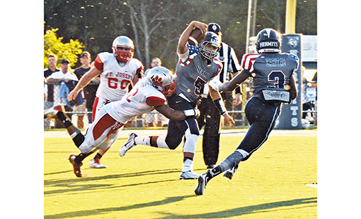 High school football kicked off in high gear for the home team St. Augustine Prep (Richland) and visiting St. Joseph (Hammonton) on Friday night, Sept. 11, for the teams’ season opener. The hometown Hermits snapped the Wildcats’ 21-game winning streak, beating St. Joseph by a final score of 33-14. At left, the Hermits’ quarterback Jose Tabora tries to elude Wildcat defenders.

Photo by Alan M. Dumoff, ccdphotolibrary.smugmug.com