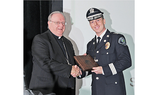 Bishop Dennis Sullivan congratulates Camden County Police Chief Scott Thomson, who accepted the Organizational Justice in Action Award for the Camden County Police Department at the annual Catholic Charities Justice for All dinner Sept. 17 at Adelphia Caterers, Deptford; Sister Graciela Rosas, left, recipient of the 2015 Individual Justice in Action Award, receives applause as she stands to accept her award.

Photos by Alan M. Dumoff