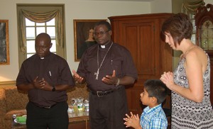 Bishop Sanctus Lino Wanok, from Uganda, blesses the Kiger house Aug. 31 with Father Robert Ngageno, parochial vicar at St. Gabriel the Archangel Parish, Carneys Point, and residents Suzanne and Sam Cooke. The Mannington Township home, built around 1720, became a  refuge for oppressed Catholics during British rule. Photos by James A. McBride