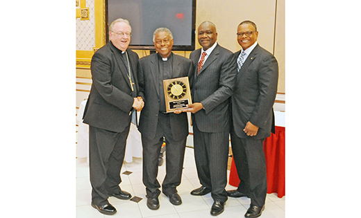 Msgr. Leonard G. Scott, retired pastor and former judicial vicar, accepts the Racial Justice Lifetime Achievement Award at the Racial Justice Commission Awards Dinner Sept. 10 at Adelphia Restaurant, Deptford. Pictured from left are Bishop Dennis Sullivan; Msgr. Scott; James E. Andrews, coordinator; and Curtis H. Johnson, Jr., chairperson. Msgr. Michael Doyle, pastor of Sacred Heart Parish, Camden, was the recipient of the Racial Justice Award, and Sister Karen Dietrich of Catholic Partnership Schools received the Many Faces in God’s House Award.

Photo by Alan M. Dumoff