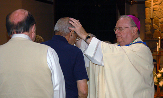 Bishop Dennis Sullivan and Father Robert Hughes (below, Vicar General, administer the sacrament of the anointing of the sick during a Mass of healing and thanksgiving for cancer patients and survivors at Church of the Holy Family in Sewell on Oct. 13.

Photos by James A. McBride