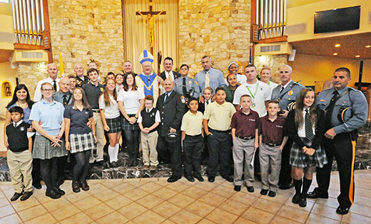 Bishop Dennis Sullivan stands with Catholic school students and their parents after celebrating the Blue Mass at St. Agnes Church, Our Lady of Hope Parish, Blackwood, on Sept. 29. The annual Blue Mass honors the dedication and service of law enforcement officers, firefighters, and emergency responders who live and work in the Camden Diocese.

Photo by Alan M. Dumoff, more photos ccdphotolibrary.smugmug.com