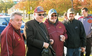Bishop Dennis Sullivan stands with Jack Heath and Edward F. Beckett, principal of Gloucester Catholic High School during the school’s Ross-Kupcha Road Race Oct. 24 in National Park. Bottom, the start of the race. Photos by James A. McBride