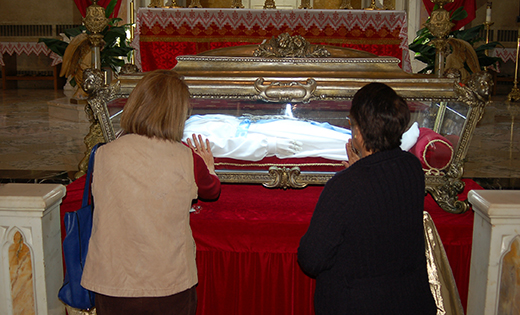 Above, Women pray before the relics of Saint Maria Goretti at Saint Peter Church, Merchantville, on Oct. 7. Right, the major relics, which are virtually all of the skeletal remains of the saint, known as the “patroness of purity,” made a one-day stop at the church while on a U.S. “pilgrimage of mercy” this fall.

Photos by James A. McBride