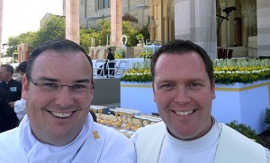 Above, Father Michael M. Romano (right), director of Vocations for the Diocese of Camden, stands with Rev. Mr. Edward Kennedy before the papal Mass in Washington, D.C. Bottom, seminarians on the bus on their way to Washington.