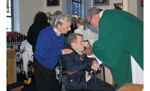 Joseph Kronberger of Franklinville receives Communion from Deacon Jerry Jablonowski, director of VITALity Catholic Health Care, Diocese of Camden, during a Mass for the sick Nov. 20 at Our Lady of Peace Parish, St. Mary Church, Williamstown. Also pictured is Dominica Kronberger. Bishop Dennis Sullivan celebrated the Mass, which was sponsored by the diocese’s Home and Parish Healthcare Services, especially for individuals dealing with Alzheimer’s and their family and caregivers.

Photo by James A. McBride