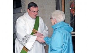 Rev. Mr. Edward Kennedy greets a parishioner after Mass at St. Raymond Church, St. John Neumann Parish, North Cape May, on Nov. 7. Photo by Alan M. Dumoff