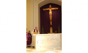 On Dec. 20 in West Collingswood, Bishop Dennis Sullivan dedicated the new altar and sanctuary at Most Precious Blood Parish, Transfiguration Church at a noon Mass, celebrated in both English and Vietnamese. With Bishop Sullivan, pastor Father Joseph An Nguyen and other priests concelebrated the liturgy for the first time at the altar. Above, Bishop Sullivan pours chrism on the altar before anointing it as part of the Rite of Dedication. Photo by James A. McBride
